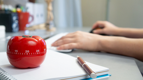 Unseen student studying with a timer
