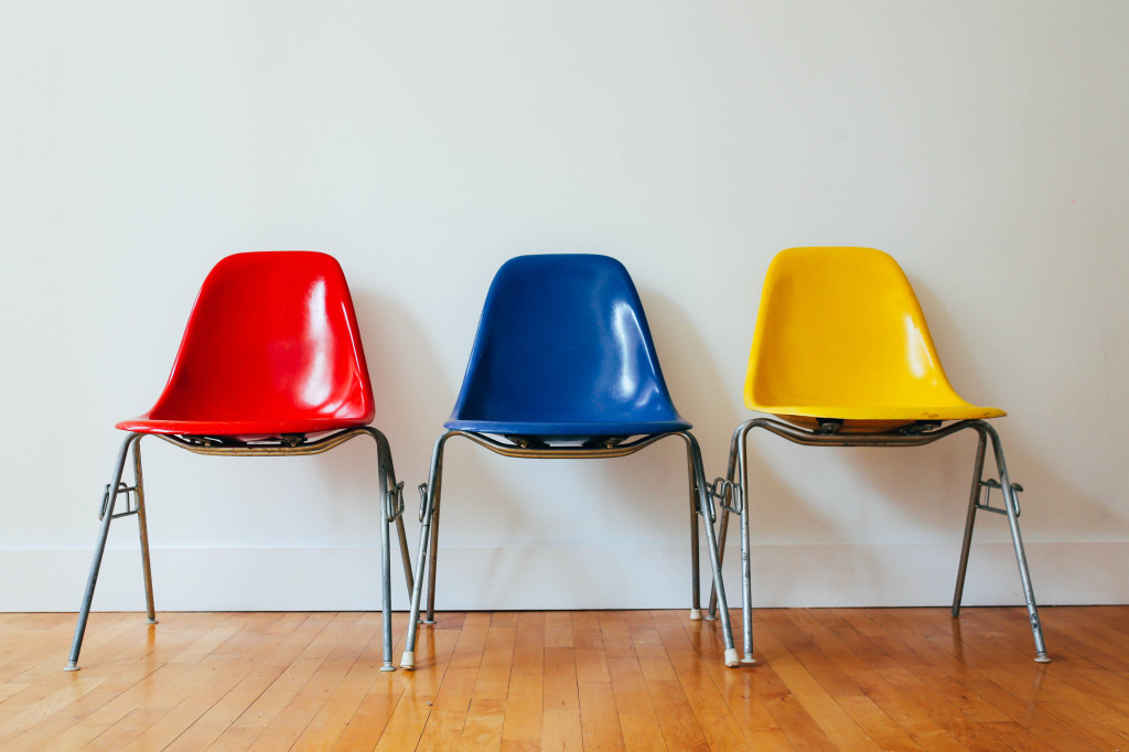 row of chairs - one is read, another is blue and the last is yellow